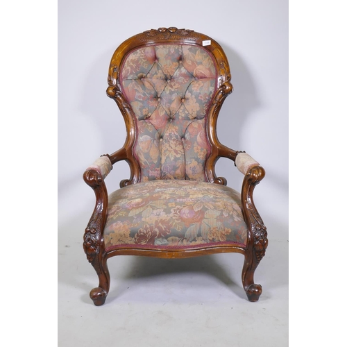 1120 - A Victorian style carved show frame walnut open armchair, with shaped back, raised on cabriole suppo... 