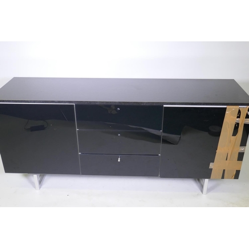 1121 - A Ronald Schmitt contemporary black glass cabinet with granite top over three drawers, flanked by cu... 