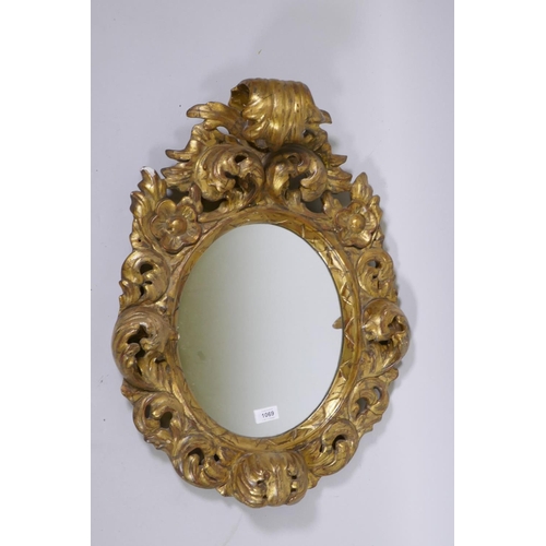 1188 - An Italian carved giltwood wall mirror, 67cm high