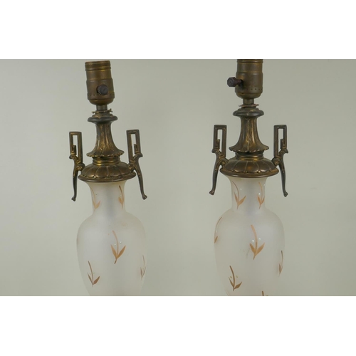 22 - Pair of etched glass table lamps with gilt and enamel decoration and brass mounts, raise on marble b... 