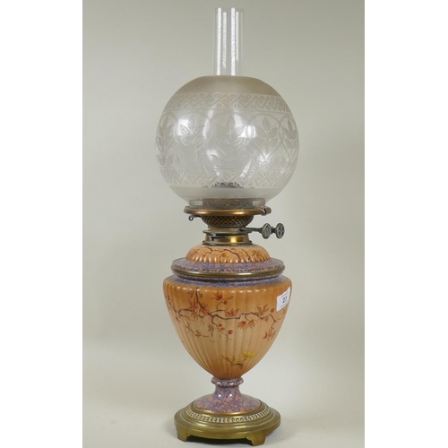 23 - A Victorian ceramic oil lamp with fluted body and brass mounts, glass reservoir, Wright & Butler... 