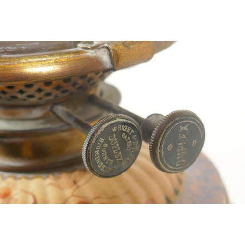 23 - A Victorian ceramic oil lamp with fluted body and brass mounts, glass reservoir, Wright & Butler... 