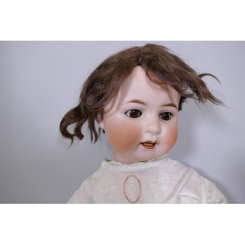 25 - An antique Heubach Koppelsdorf porcelain head doll with rolling eyes, No 300.3, 57cm high, and anoth... 