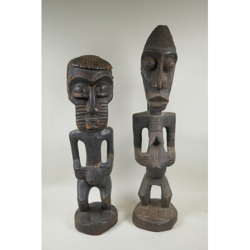 251 - An African tribal carved wood figure of a bearded man, and another similar of a woman, largest 68cm ... 