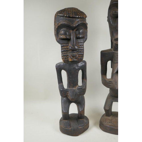 251 - An African tribal carved wood figure of a bearded man, and another similar of a woman, largest 68cm ... 