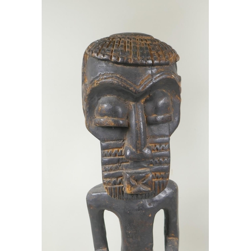 251 - An African tribal carved wood figure of a bearded man, and another similar of a woman, largest 68cm ... 