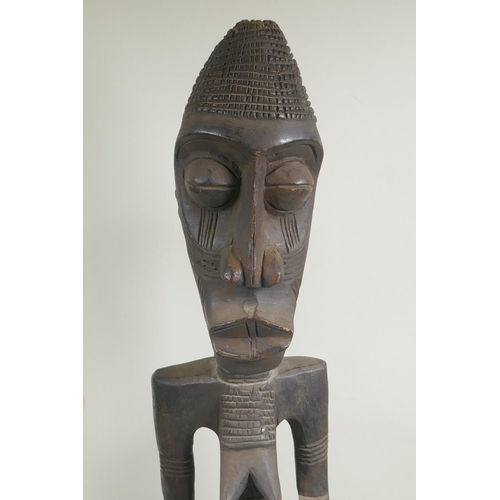 251 - An African tribal carved wood figure of a bearded man, and another similar of a woman, largest 68cm ... 