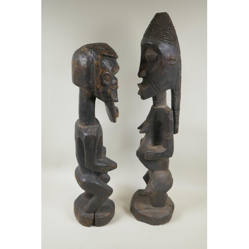 251 - An African tribal carved wood figure of a bearded man, and another similar of a woman, largest 68cm ... 