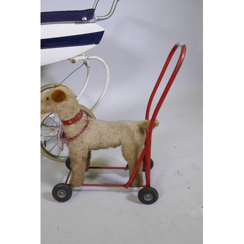 252 - A child's Tansad toy pram, a Pedigree Soft Toys push along dog walker and two celluloid dolls with r... 