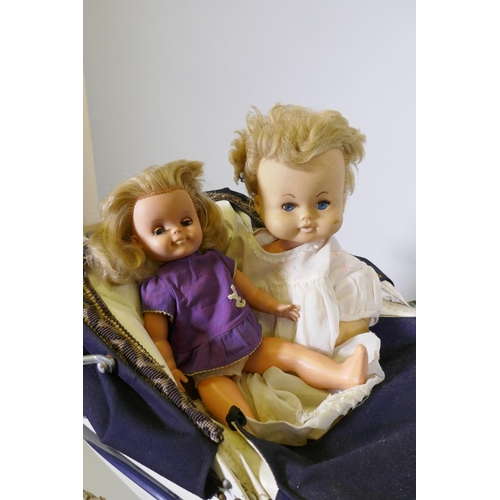 252 - A child's Tansad toy pram, a Pedigree Soft Toys push along dog walker and two celluloid dolls with r... 