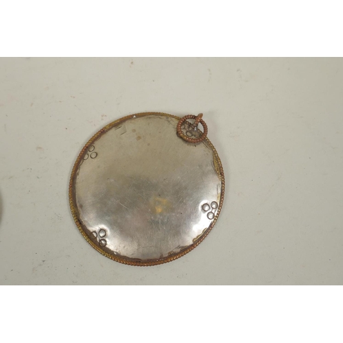 255 - A pair of Tibetan brass cymbals and a white metal mirror pendant, 10cm diameter