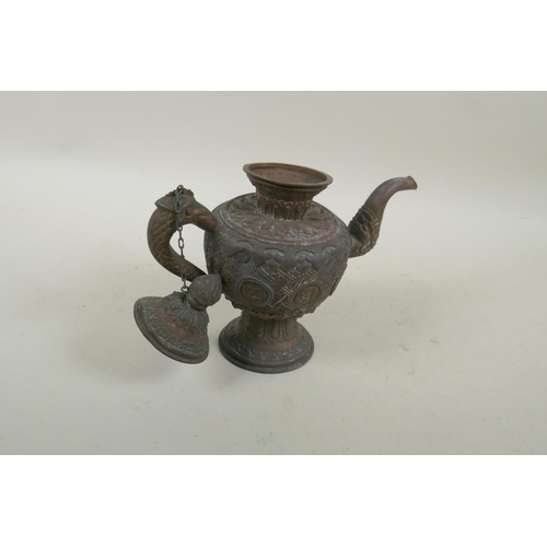 258 - A Tibetan copper and brass repousse tea pot with phoenix head handle and dragon head spout, 21cm hig... 