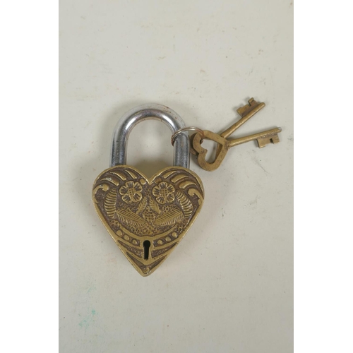 260 - A Tibetan bronze heart shaped padlock, indistinct impressed marks verso, 12cm high