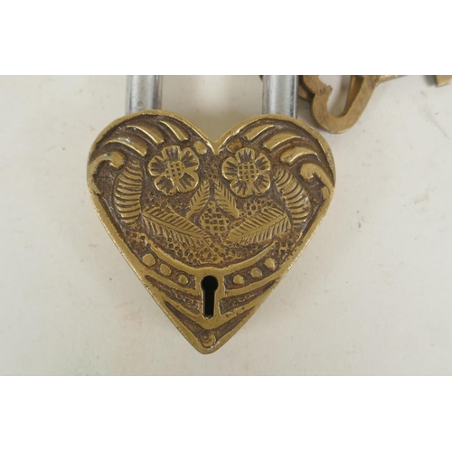 260 - A Tibetan bronze heart shaped padlock, indistinct impressed marks verso, 12cm high