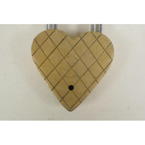 260 - A Tibetan bronze heart shaped padlock, indistinct impressed marks verso, 12cm high