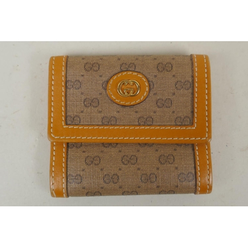 263 - A Gucci Anniversary Collection wallet, No. 64.03.110, and a smaller Gucci sample purse, marked Sampl... 