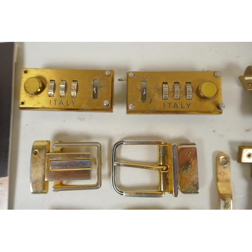 264 - A quantity of Gucci gilt metal and brass fittings, belt hooks, clasps, studs, locks, etc and a catal... 