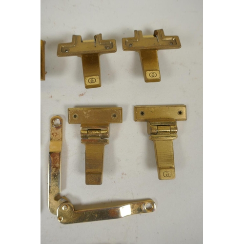 264 - A quantity of Gucci gilt metal and brass fittings, belt hooks, clasps, studs, locks, etc and a catal... 