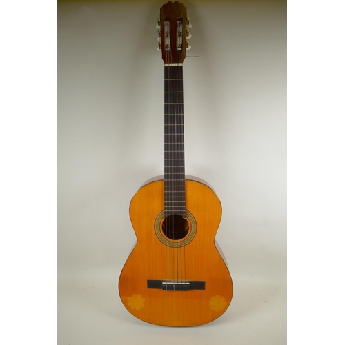 275 - A Spanish classical guitar by BM Espana, 101cm long, and a silver plated trumpet retailed by the Kin... 