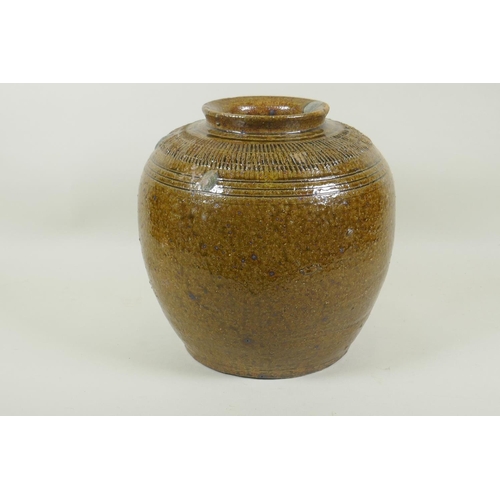 35 - An oriental green glazed stoneware pot, 26cm high