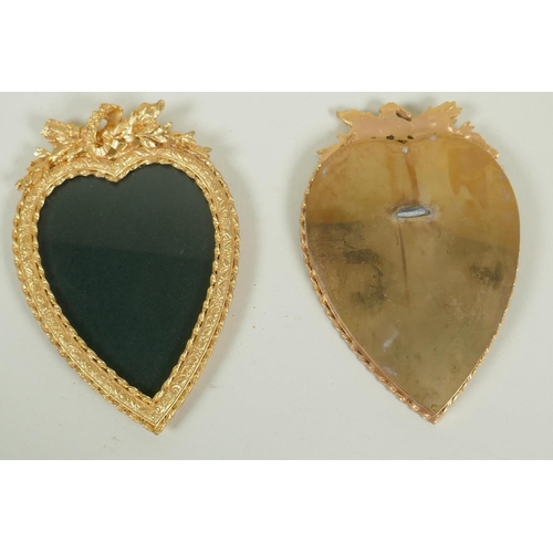 39 - Pair of gilt metal heart shaped frames with classical decoration, 18.5cm high