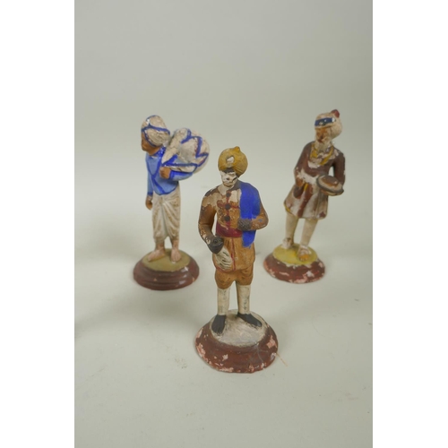 41 - A collection of twelve Indian painted plaster figures of tradespeople, AF, 17cm high