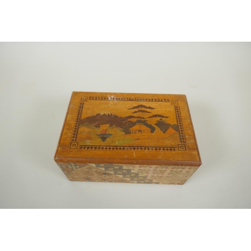 46 - A Japanese Yosegi-Zaiku marquetry puzzle box, opening to reveal a secret musical drawer, 15 x 10cm