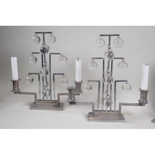 49 - A pair of mid century chromed two branch candelabra and a pair of wall sconces, 26cm high