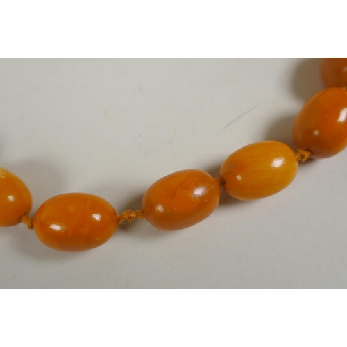 601 - A vintage butterscotch amber bead necklace, 105cm long, 51 graduated beads, largest 23mm, smallest 1... 