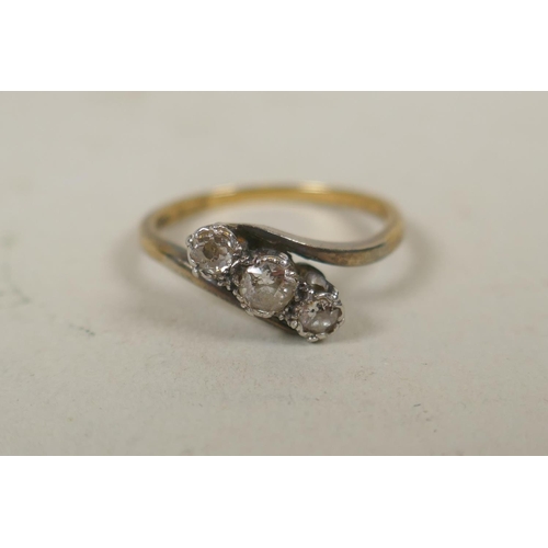 606 - 18ct gold and platinum trilogy ring set with three diamonds, approx 0.6ct, size N, 2.8g