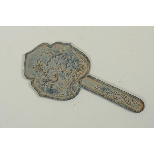 61 - Chinese bronze hand mirror, with raised decoration of a dragon and phoenix, 21cm long