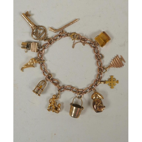 610 - 9ct gold charm bracelet, 26.4g