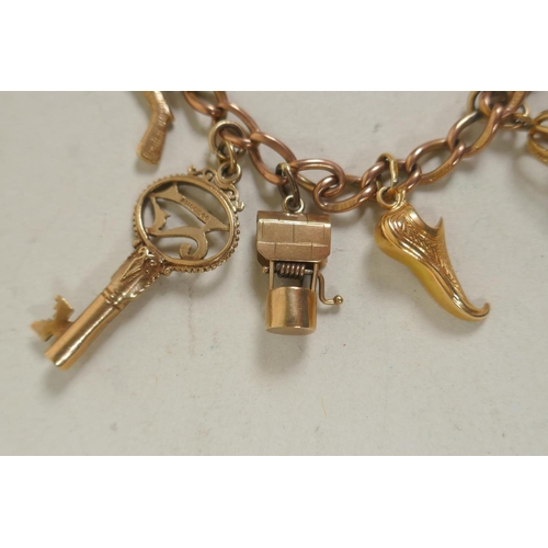 610 - 9ct gold charm bracelet, 26.4g