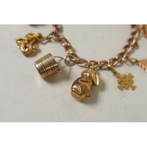 610 - 9ct gold charm bracelet, 26.4g