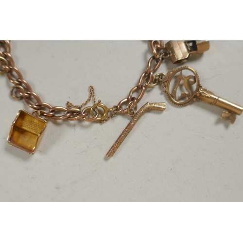 610 - 9ct gold charm bracelet, 26.4g