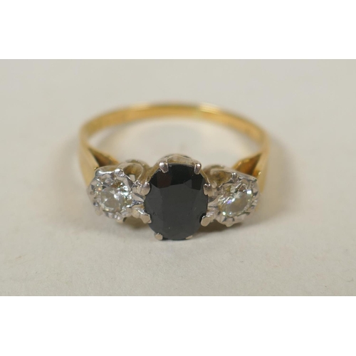 613 - 18ct gold ring set with two diamonds flanking a blue gem stone (spinel?), size R, 3.5g gross