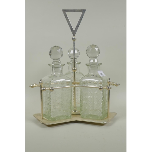 621 - Christopher Dresser style silver plated three section decanter stand with crystal glass decanters, 3... 