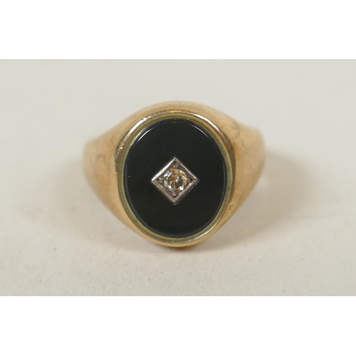 622 - 9ct gold signet ring set with jet and a small diamond, size J/K, 8.5g