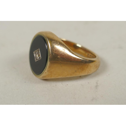 622 - 9ct gold signet ring set with jet and a small diamond, size J/K, 8.5g