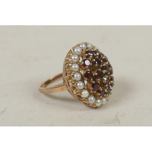 623 - 9ct gold dress ring set with 18 seed pearls and garnets, size R, 9g gross