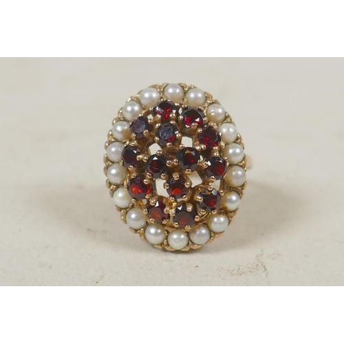 623 - 9ct gold dress ring set with 18 seed pearls and garnets, size R, 9g gross