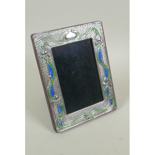 631 - An Art Nouveau style sterling silver and enamel photo frame, 8.5 x 13cm aperture