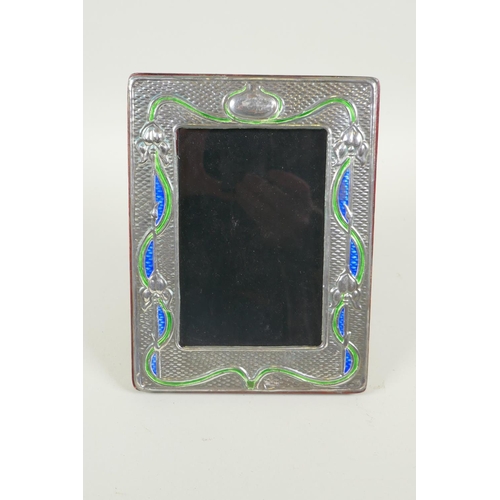 631 - An Art Nouveau style sterling silver and enamel photo frame, 8.5 x 13cm aperture