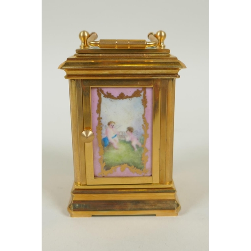 635 - A miniature gilt brass carriage clock with Sevres style paste panels, the dial with day and date sub... 