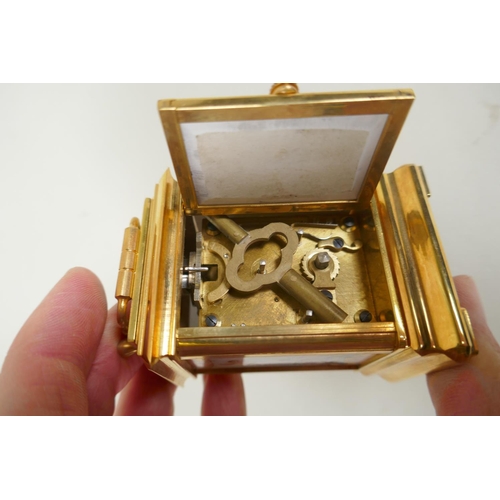 635 - A miniature gilt brass carriage clock with Sevres style paste panels, the dial with day and date sub... 