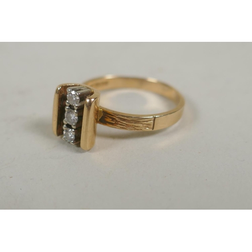 662 - An 18ct gold three stone diamond ring, size M, approx 0.2ct total, 3.8g gross