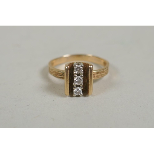 662 - An 18ct gold three stone diamond ring, size M, approx 0.2ct total, 3.8g gross