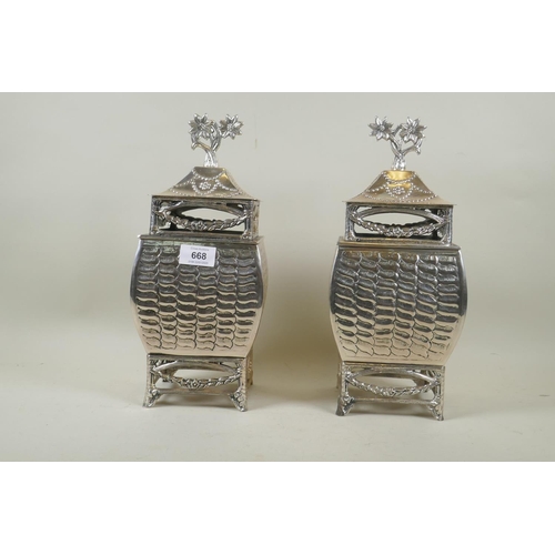 668 - A pair of silver plated urns and covers, 33cm high