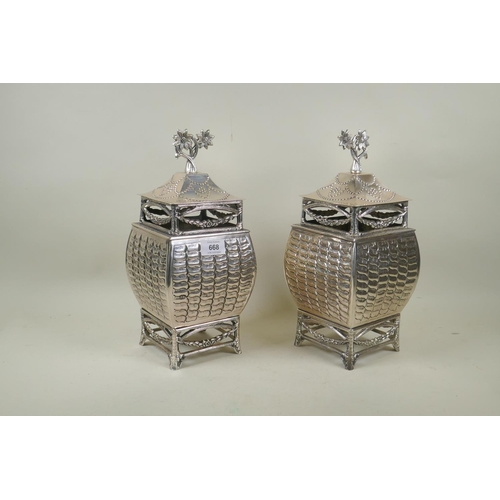 668 - A pair of silver plated urns and covers, 33cm high