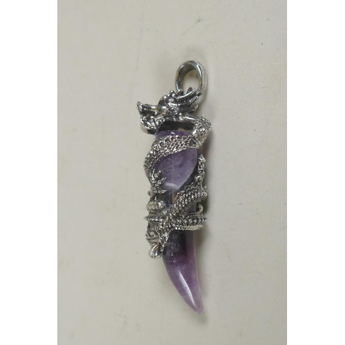 671 - A metal mounted amethyst pendant with dragon decoration, 6cm